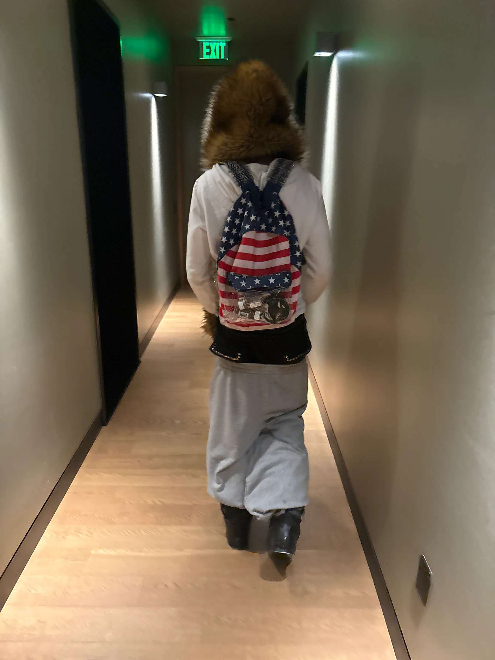 Club Moxy campaign model walking down a hallway.
